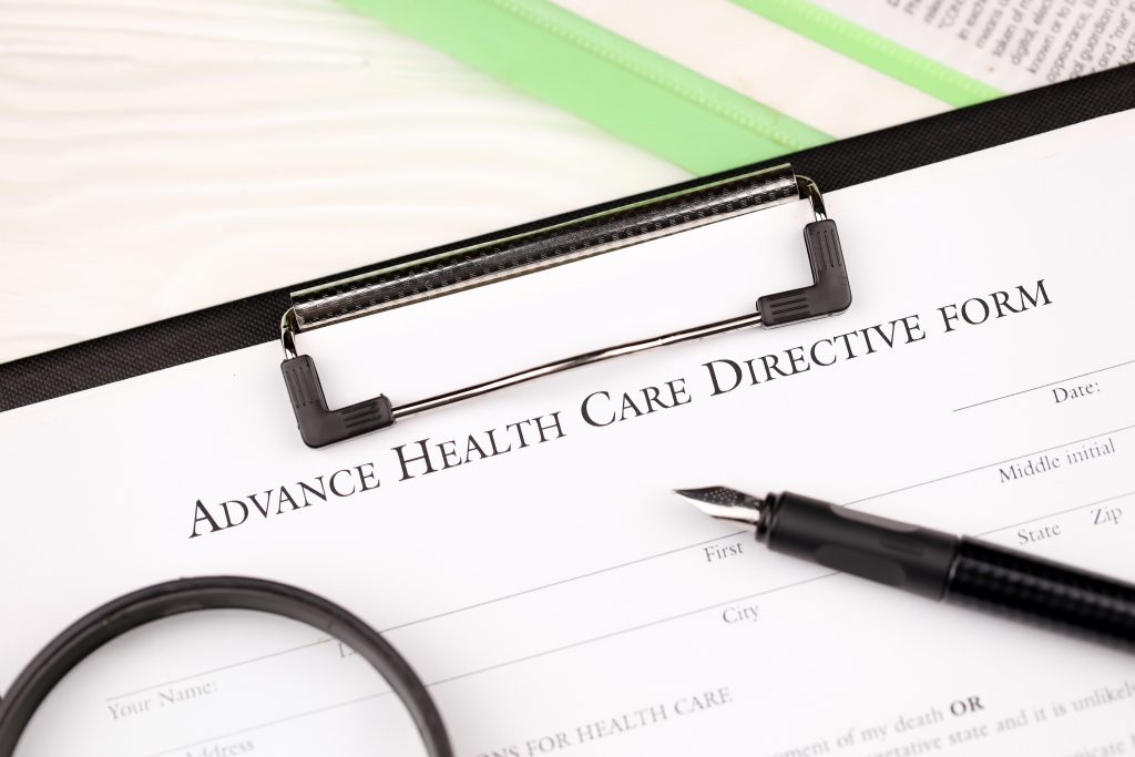 advance health care directive blank form on a4 tablet lies on office table with pen and magnifying glass